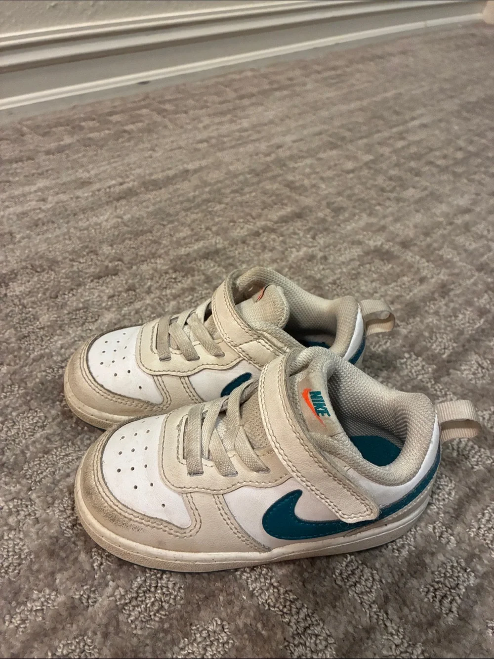 Nike Kids White Sneakers with Teal Swoosh and Orange Logo